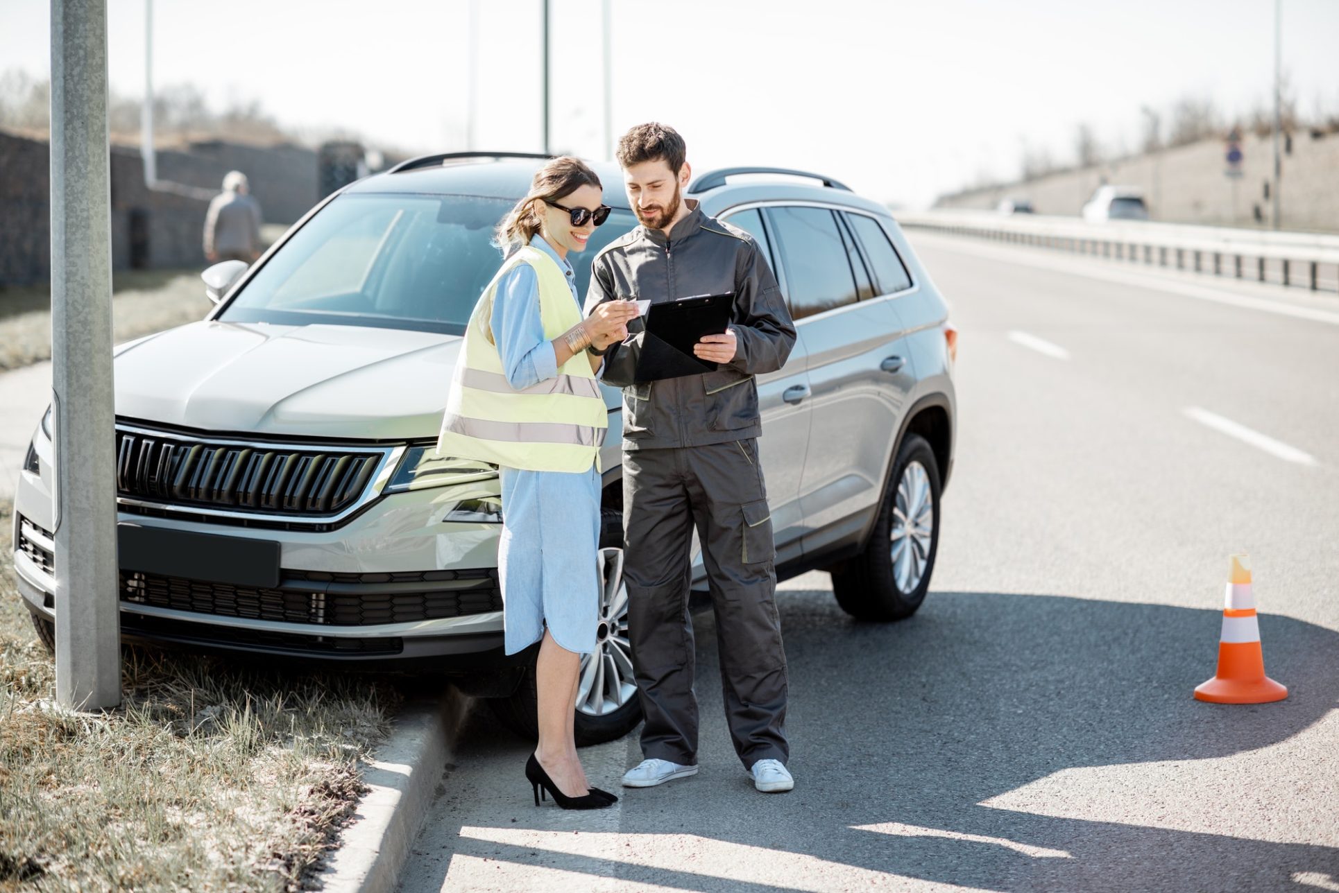 Woman with road worker during the road accident